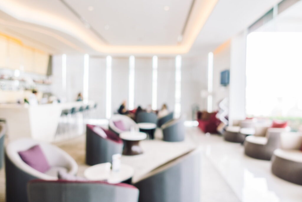Blurred interior of a modern hotel lobby.